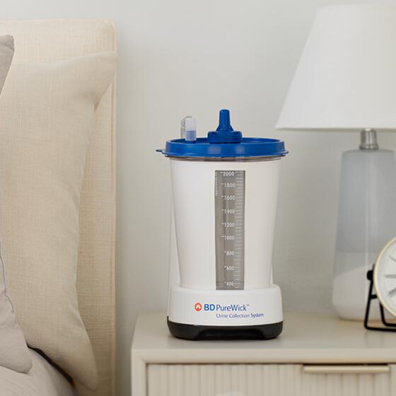 The PureWick&trade; Urine Collection System sitting in a side table next to a couch